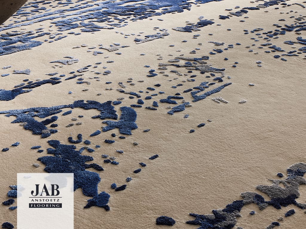 cremefarbener Teppich mit blauen Pinselstrichen